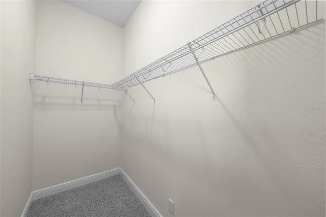 a view of a swimming pool with a bench and trees