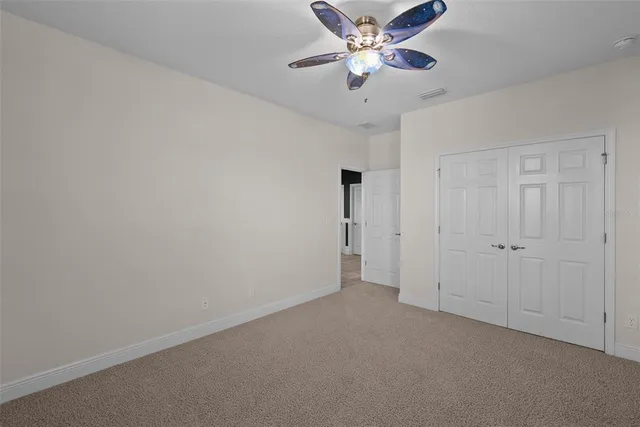 a view of swimming pool with red chairs