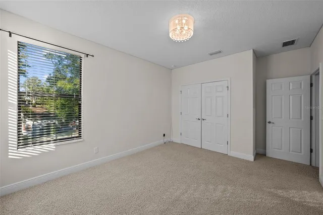 a front view of a house with a yard and trees