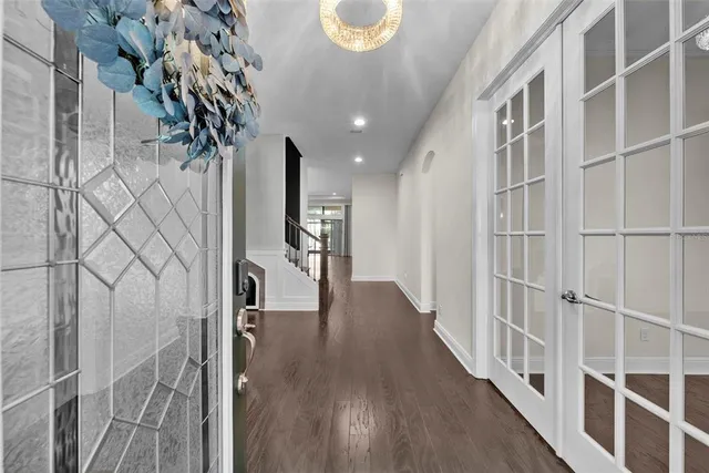 a large kitchen with kitchen island a stove a sink a center island and wooden floor