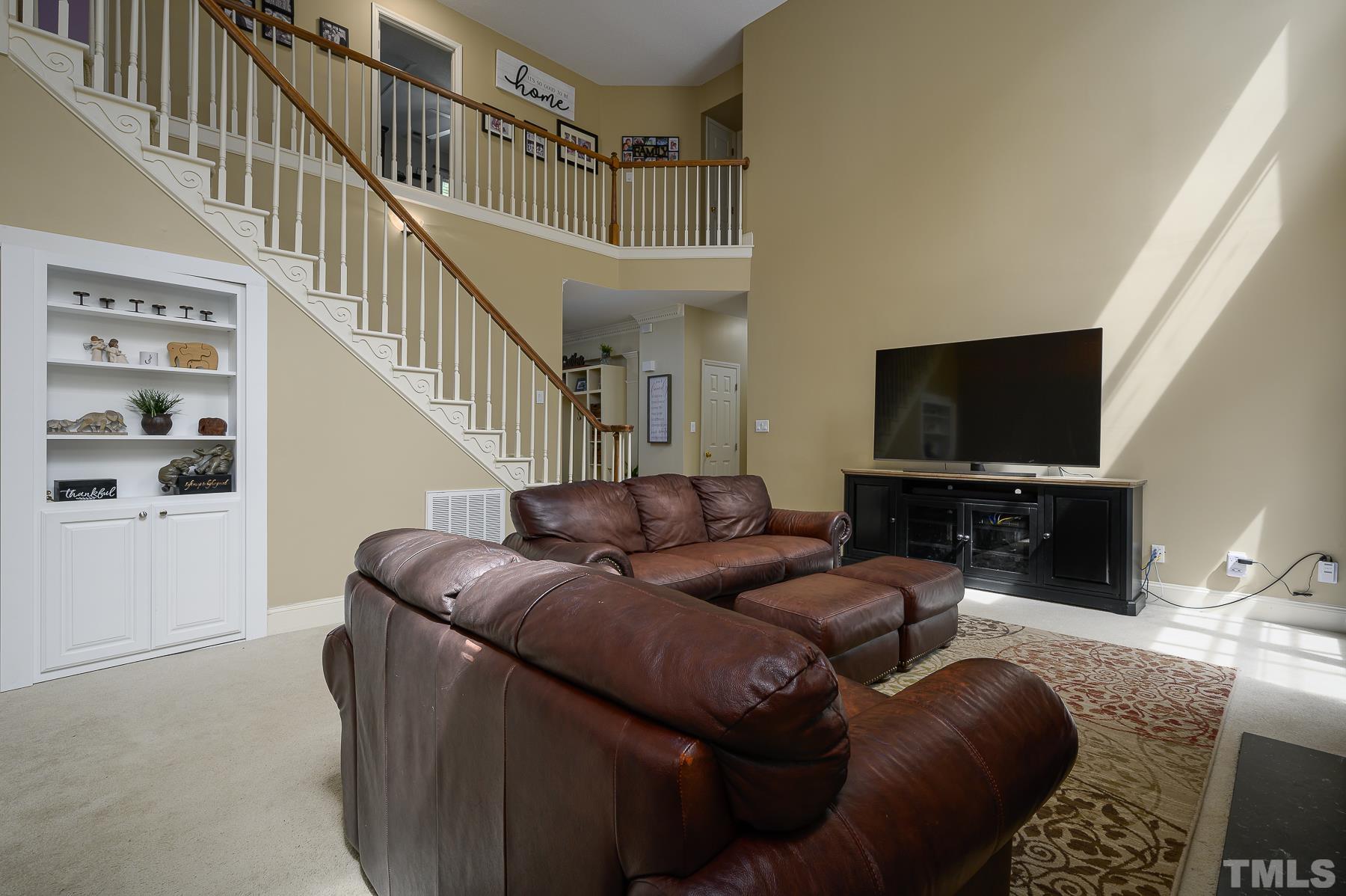 701 Modena Drive Cary, NC 27513 - Photo 15 of 39 a living room with furniture and a flat screen tv