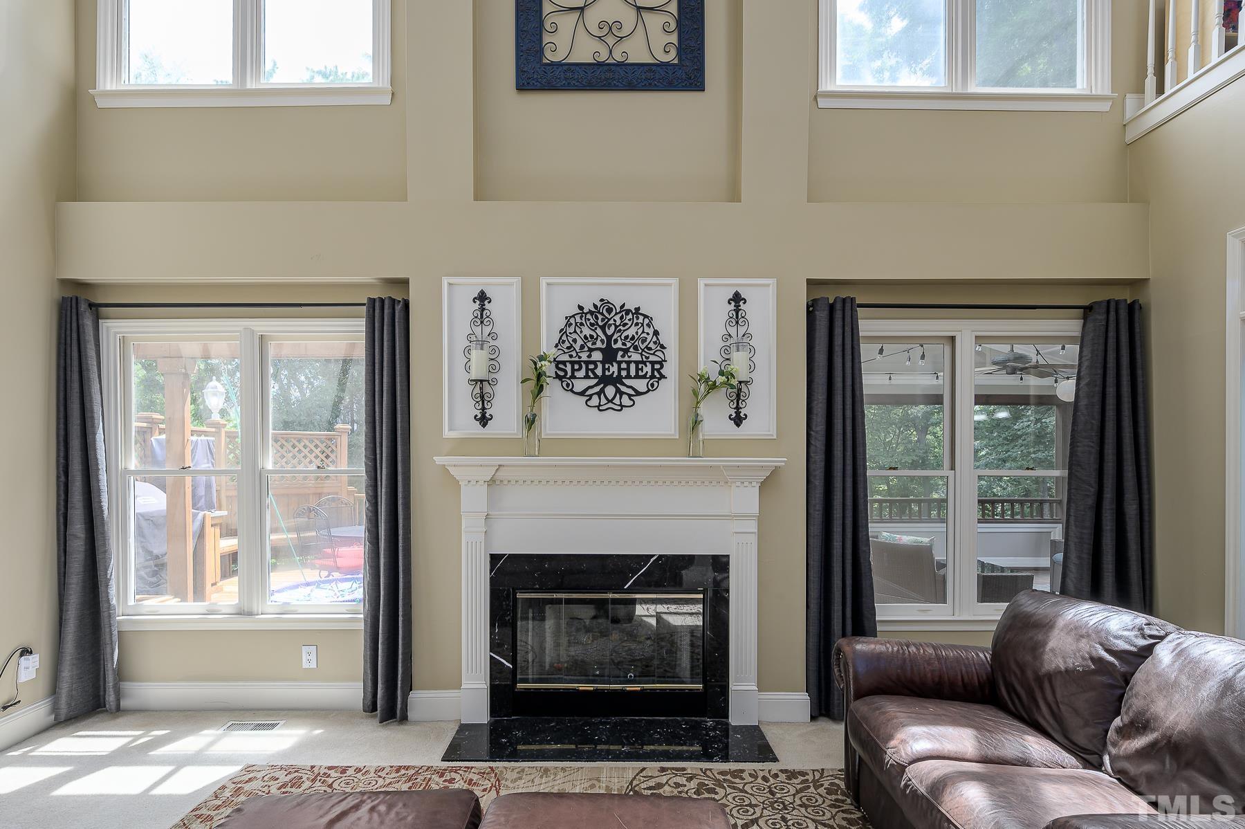 701 Modena Drive Cary, NC 27513 - Photo 18 of 39 a living room with furniture a window and a fireplace
