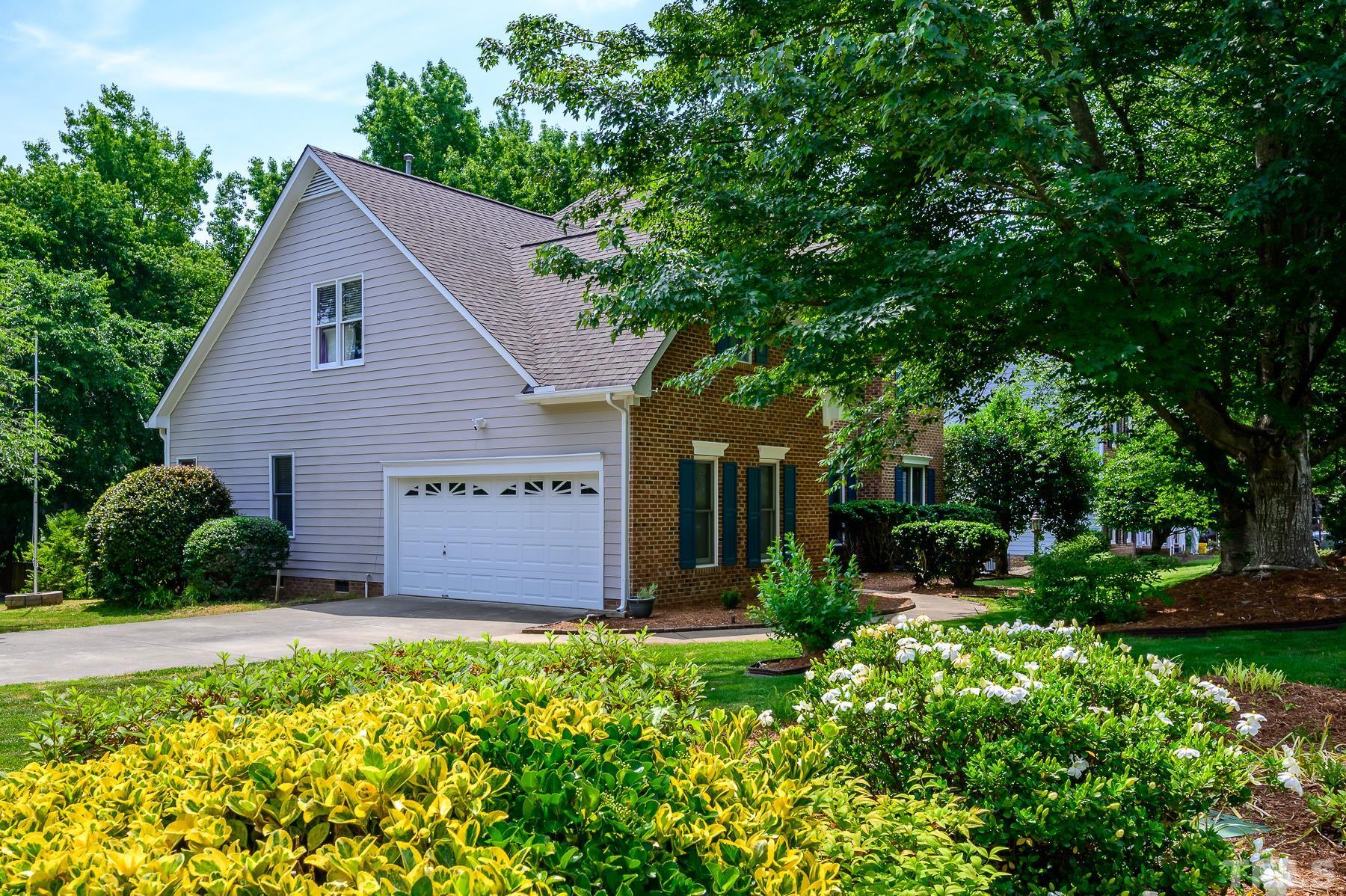 701 Modena Drive Cary, NC 27513 - Photo 2 of 39 a view of a house with a yard and potted plants
