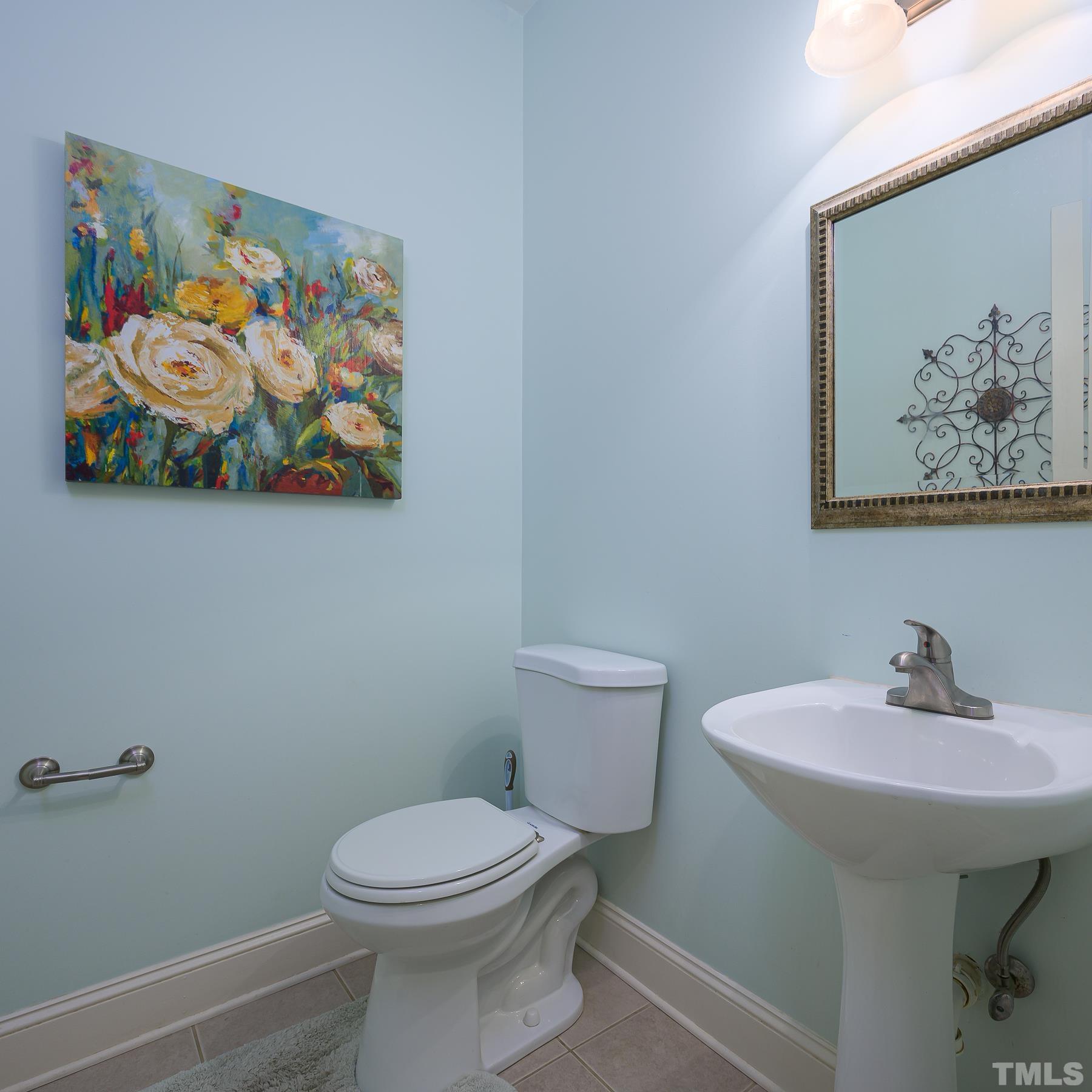 701 Modena Drive Cary, NC 27513 - Photo 25 of 39 a bathroom with a toilet and sink
