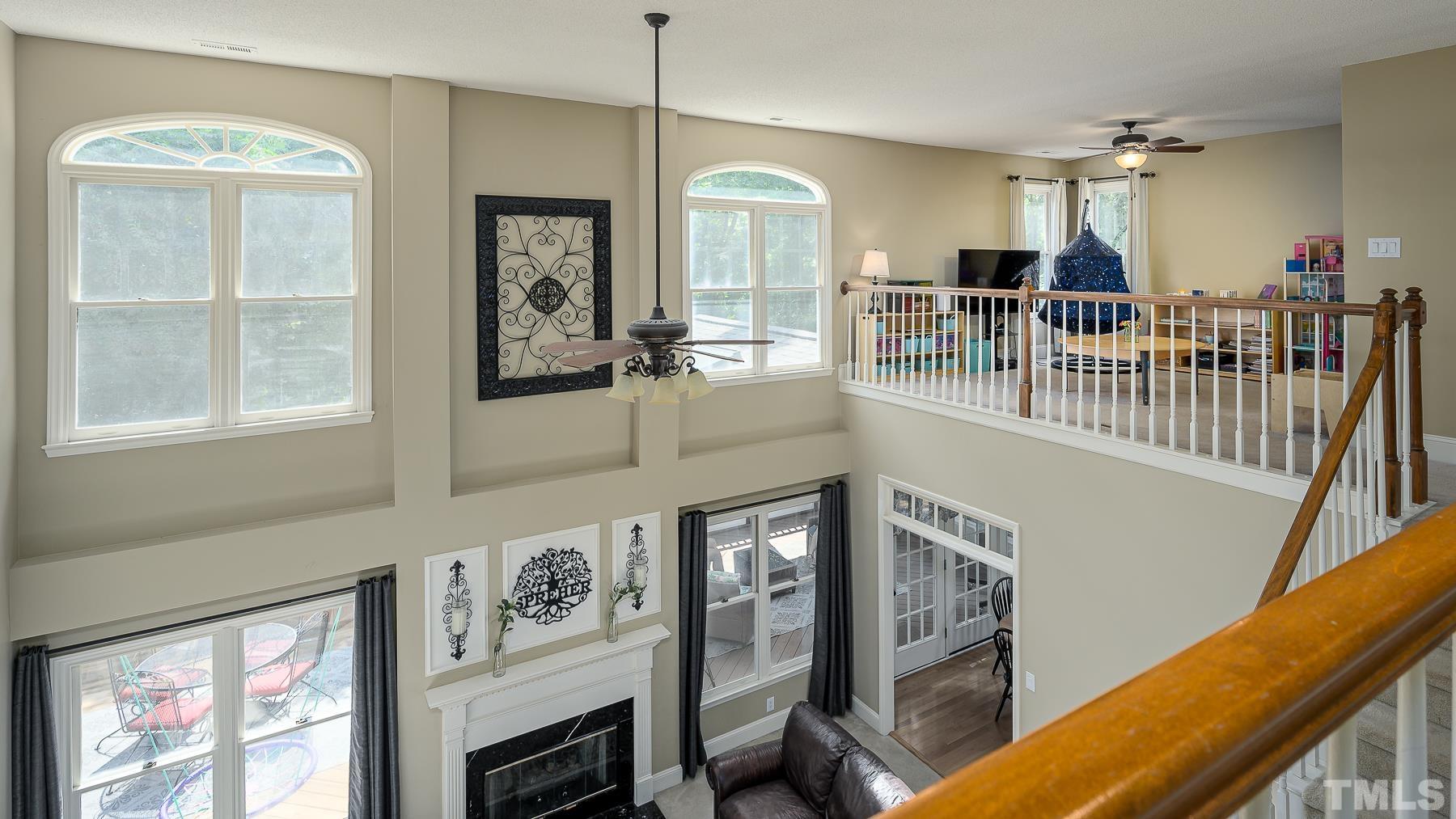 701 Modena Drive Cary, NC 27513 - Photo 26 of 39 a living room with furniture a flat screen tv and a large window