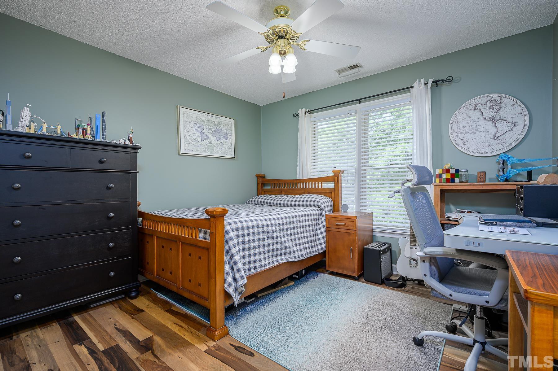 701 Modena Drive Cary, NC 27513 - Photo 28 of 39 a bed room with a bed and a chandelier