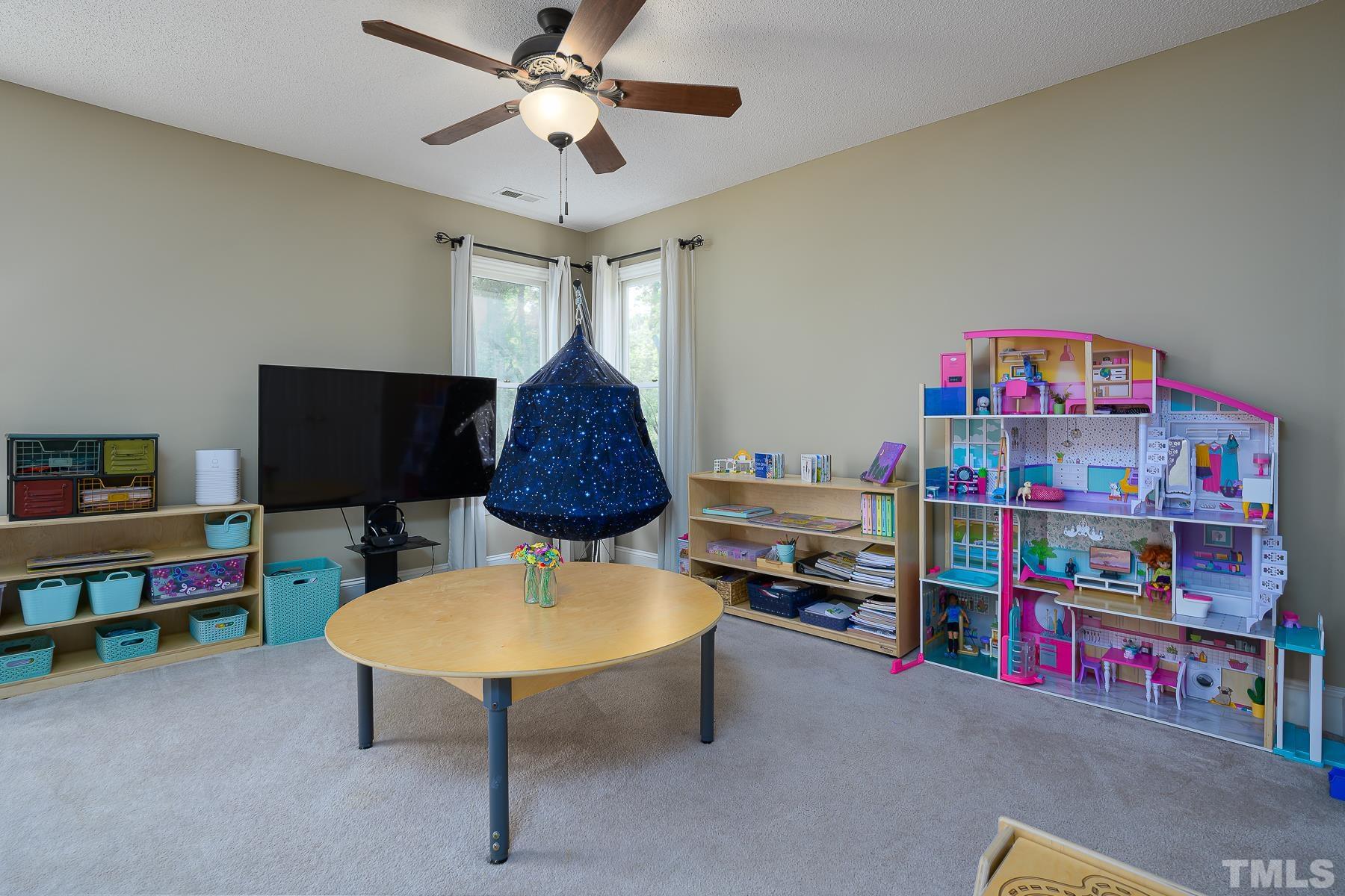 701 Modena Drive Cary, NC 27513 - Photo 30 of 39 a living room with furniture and a flat screen tv