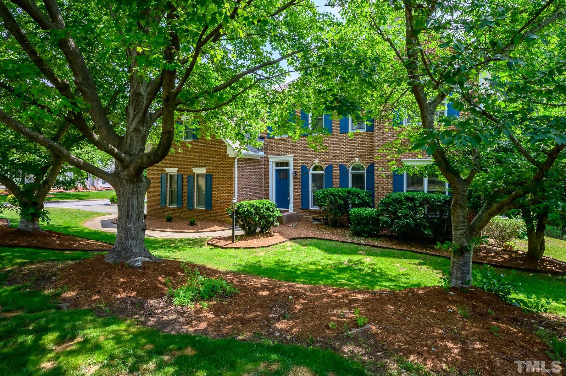 701 Modena Drive Cary, NC 27513 - Photo 3 of 39 a front view of a house with garden