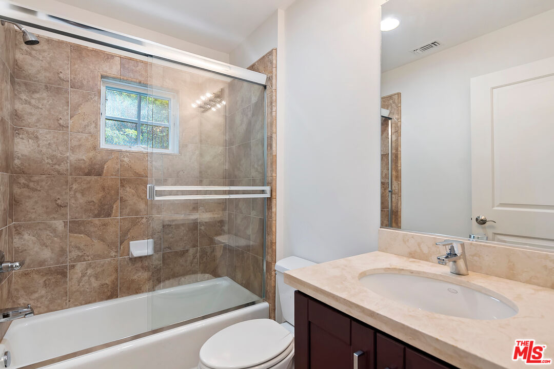 23550 Valley View Road Calabasas, CA 91302 - Photo 22 of 26 a bathroom with a granite countertop sink toilet and shower