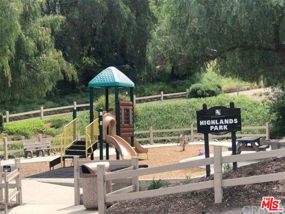 23550 Valley View Road Calabasas, CA 91302 - Photo 26 of 26 a view of a patio with a table chairs and a floor to ceiling window