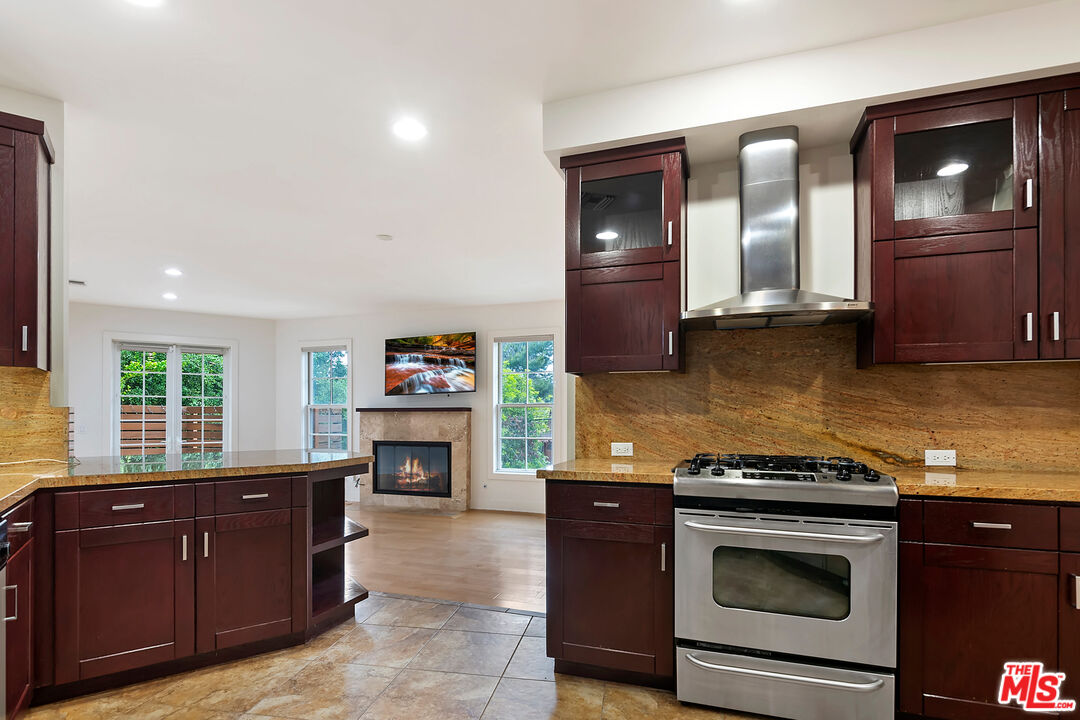 23550 Valley View Road Calabasas, CA 91302 - Photo 5 of 26 a kitchen with granite countertop a stove top oven microwave and refrigerator