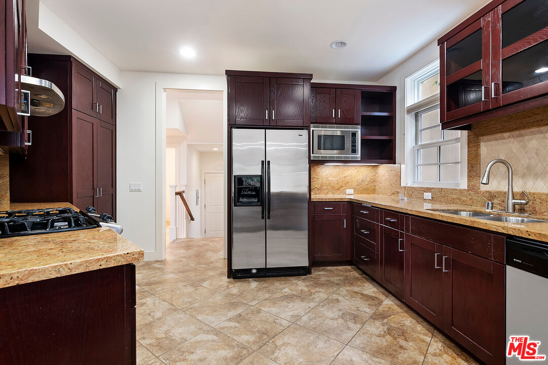 23550 Valley View Road Calabasas, CA 91302 - Photo 7 of 26 a kitchen with stainless steel appliances granite countertop a refrigerator and a stove top oven