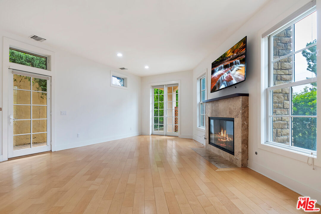 23550 Valley View Road Calabasas, CA 91302 - Photo 8 of 26 a view of an empty room with a fireplace and a window