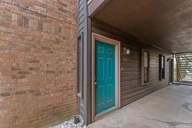 a view of a brick house with a large window