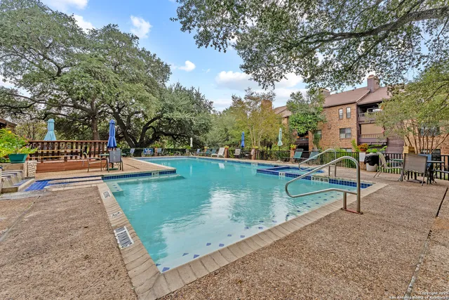 a view of pool with a yard