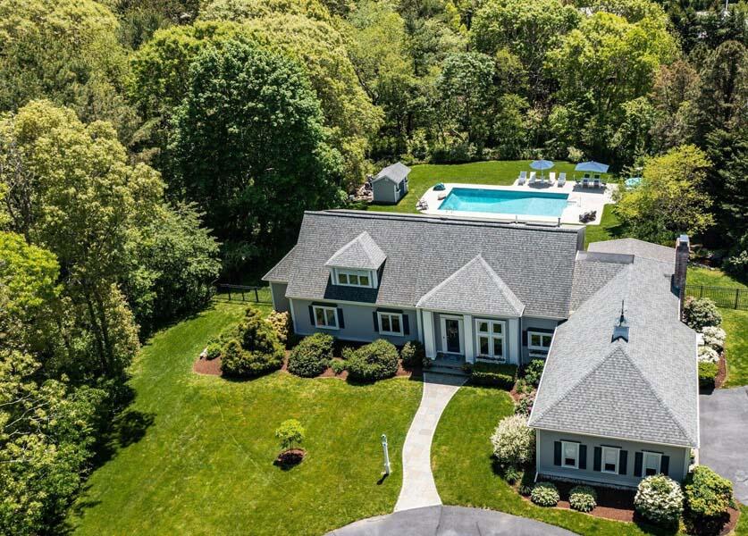 a aerial view of a house with swimming pool and big yard