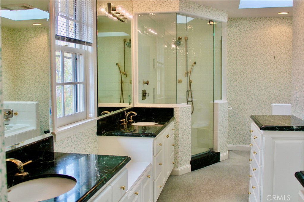 6832 Verde Ridge Road Rancho Palos Verdes, CA 90275 - Photo 15 of 21 a bathroom with a granite countertop sink a toilet a mirror and vanity