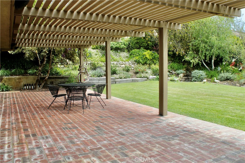 6832 Verde Ridge Road Rancho Palos Verdes, CA 90275 - Photo 7 of 21 a view of a patio with a table chairs and a yard