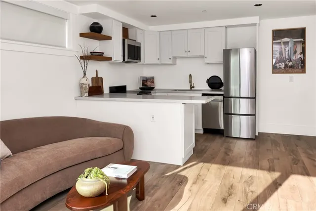 a kitchen with stainless steel appliances granite countertop a refrigerator sink and stove