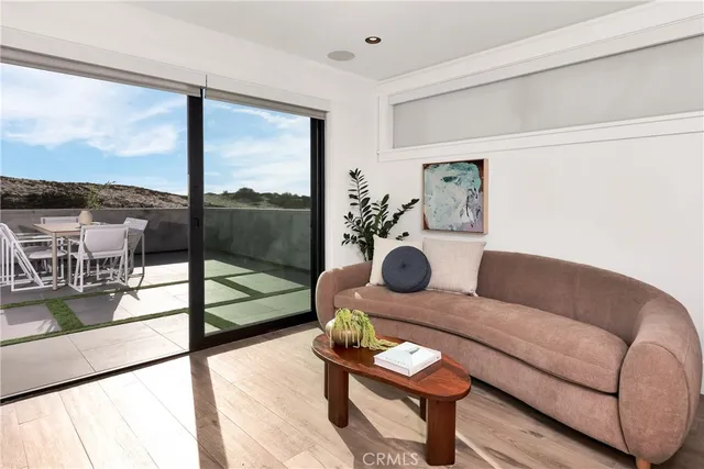 a living room with furniture and a floor to ceiling window