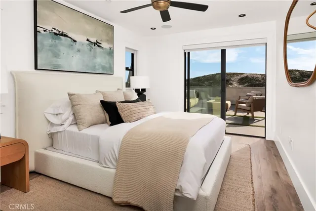 a spacious bedroom with a bed and glass window