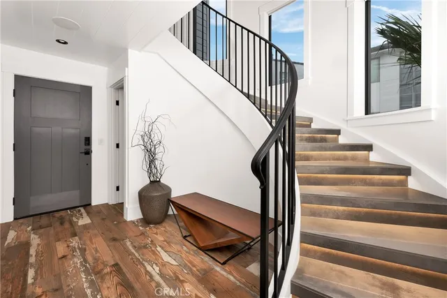 a view of entryway and hall with wooden floor