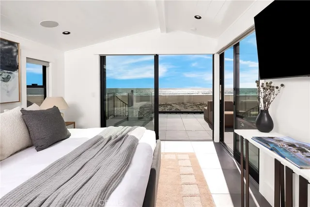 a bedroom with a large bed and a large window