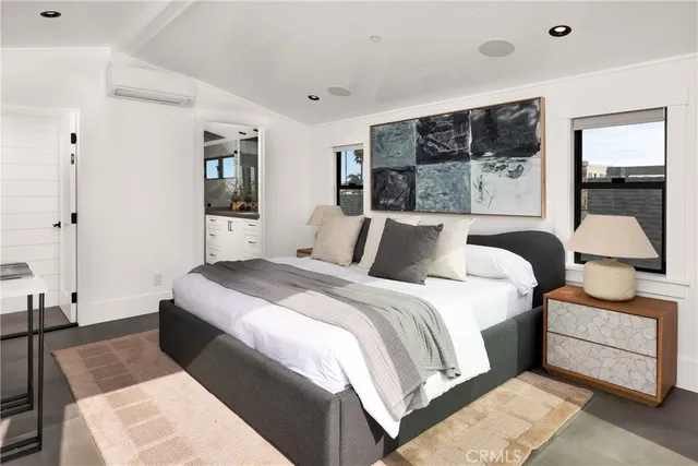 a bedroom with a bed and glass window