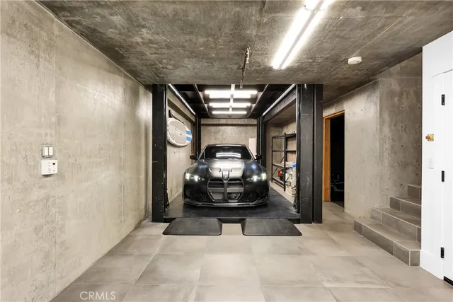 a hallway with a couch and chandelier