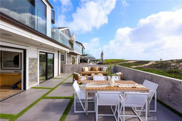 a view of a patio with table and chairs a barbeque with wooden floor and fence