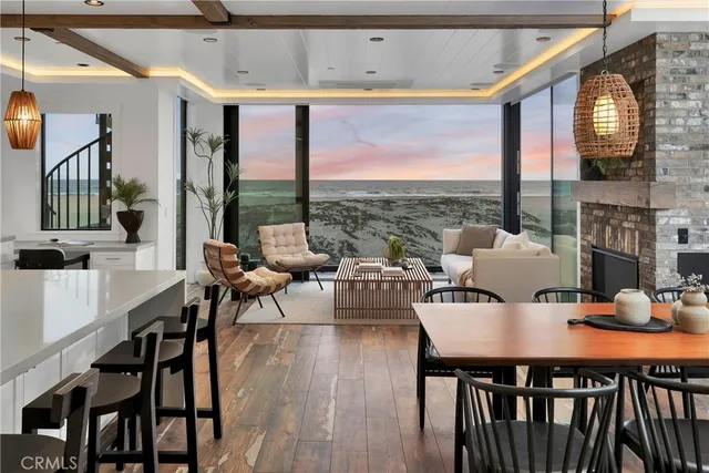 a dining room with furniture a chandelier and wooden floor