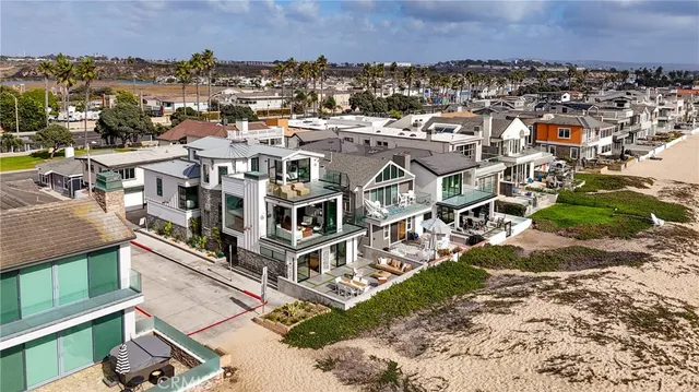 an aerial view of a house with a yard garage and mountain view in back