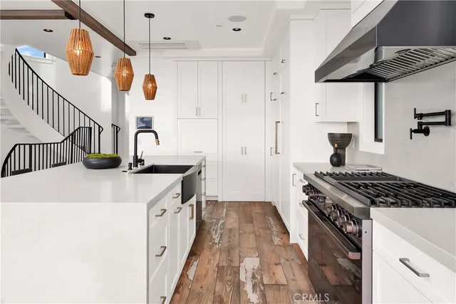 a kitchen with a sink a stove and cabinets