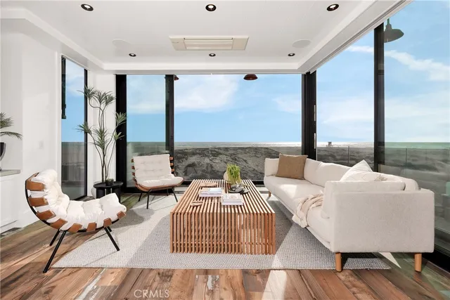a living room with furniture and a floor to ceiling window