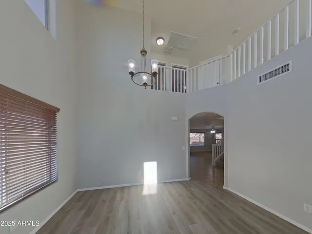 a view of wooden floor and windows in a room