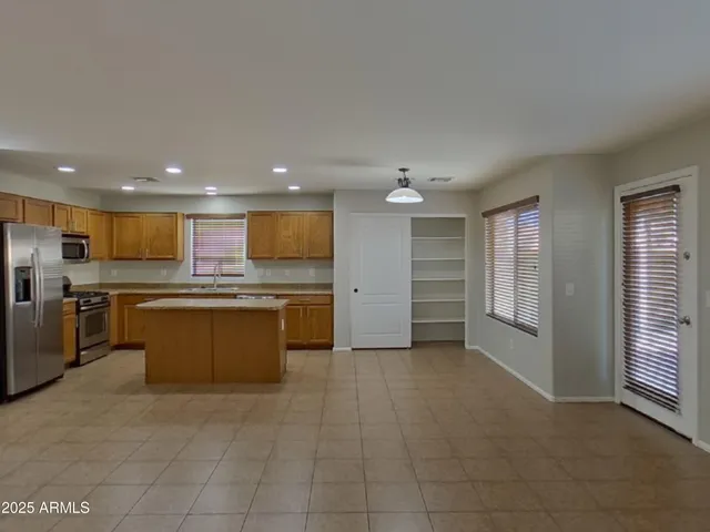 a view of a livingroom with an empty space and a window