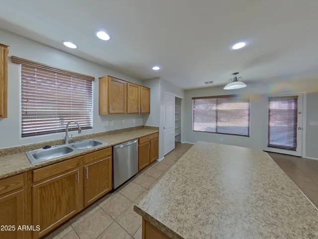 a kitchen with a refrigerator and a sink