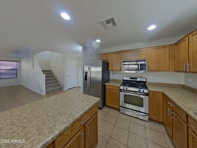 a view of a kitchen with a sink and dishwasher cabinet with wooden floor