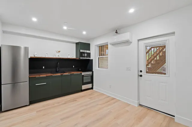 a kitchen with stainless steel appliances a refrigerator and a microwave