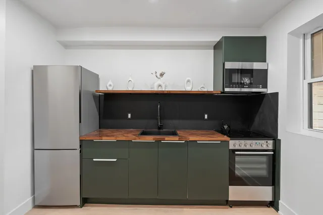 a kitchen with a sink and stainless steel appliances