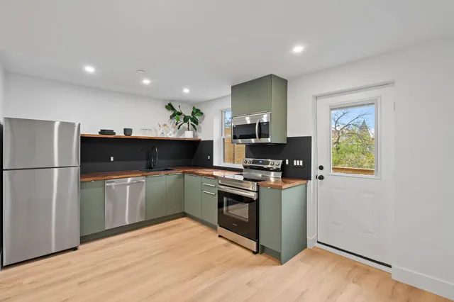a kitchen with stainless steel appliances a refrigerator and a sink