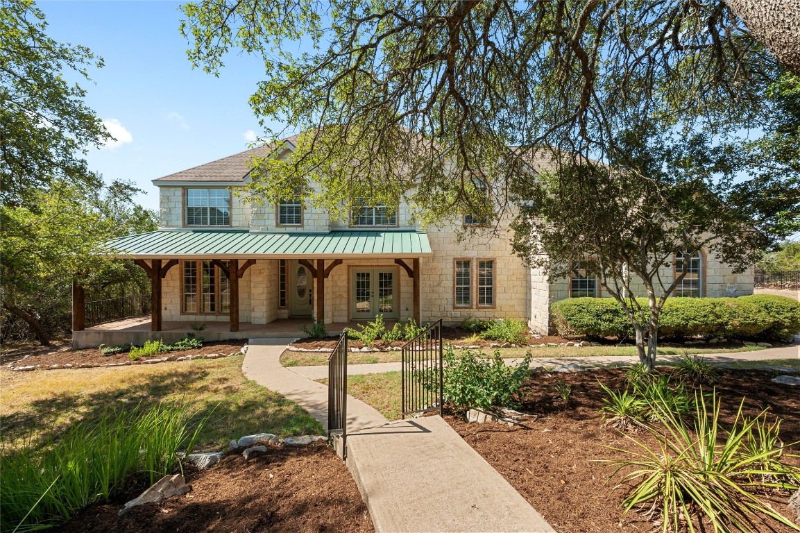 152 Hucks Hideaway Dripping Springs, TX 78620 - Photo 1 of 1 a front view of a house with garden