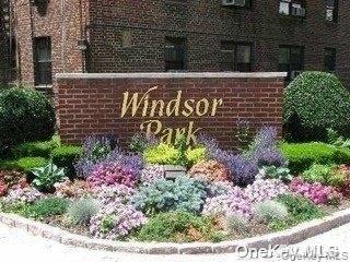 73-45 210th Street, Unit 4B Queens, NY 11364 - Photo 1 of 12 a sign that is in front of flowers