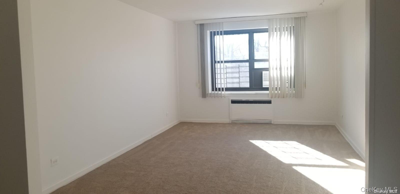 73-45 210th Street, Unit 4B Queens, NY 11364 - Photo 12 of 12 an empty room with a window