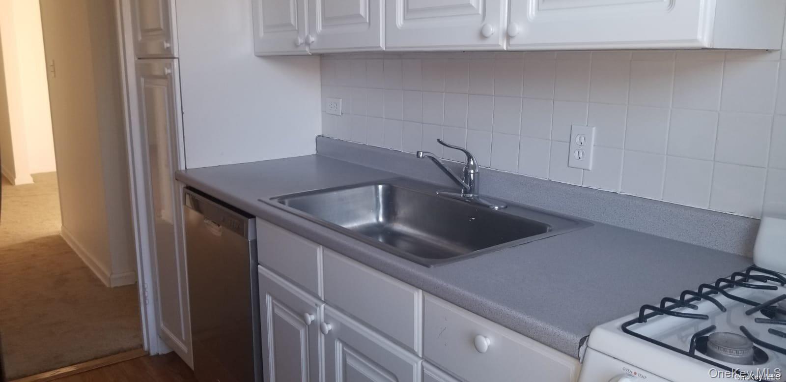 73-45 210th Street, Unit 4B Queens, NY 11364 - Photo 4 of 12 a kitchen with a sink and a stove top oven
