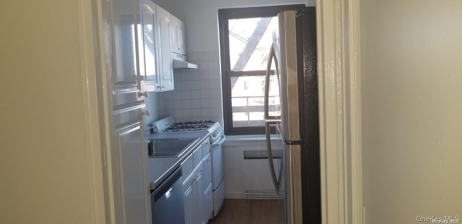 73-45 210th Street, Unit 4B Queens, NY 11364 - Photo 7 of 12 a kitchen with a window
