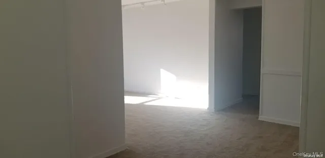 a view of an empty room and a window