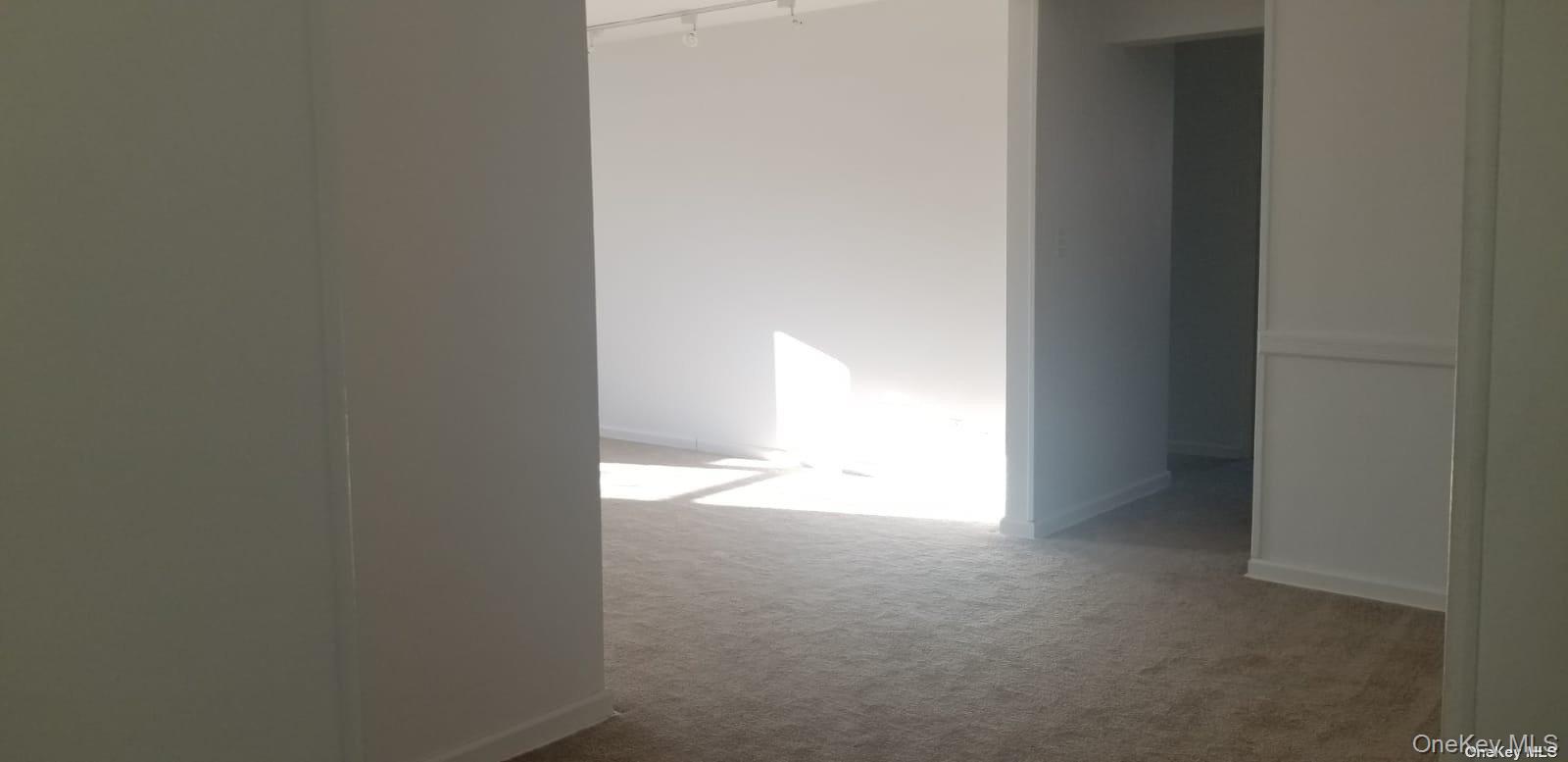 73-45 210th Street, Unit 4B Queens, NY 11364 - Photo 9 of 12 a view of an empty room and a window