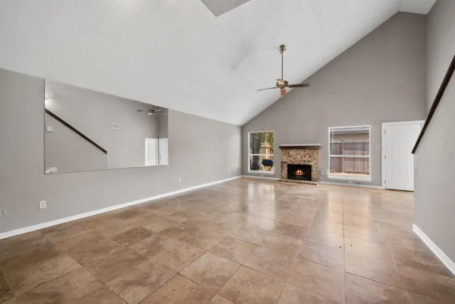 a view of an empty room with a ceiling fan