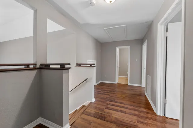 a view of a room with wooden floor and windows